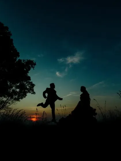 A playful silhouette of a couple at sunset. This type of shot is perfect for capturing the fun and energetic side of your relationship.