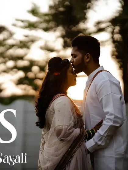 A silhouette against the golden hour sunset. This shot captures a tender forehead kiss, a simple yet powerful expression of love, with their initials marking the beginning of their story.