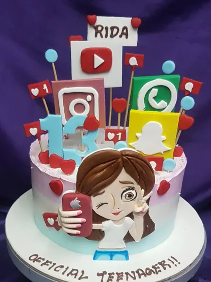 This social media cake is perfect for an "Official Teenager." It's decorated with edible icons from all their favorite apps and a fun caricature, capturing the vibe of turning 13.