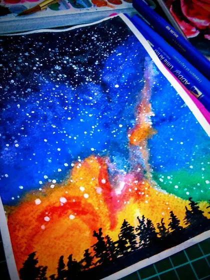 An expressive watercolor painting of a starry night sky over a forest silhouette. Even though I felt it was a 'bad attempt' at the time, I love the vibrant, unpredictable way the colors blended.