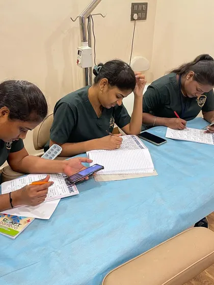 Another shot of the clinic staff deeply focused on their communication exercises. My goal is to provide them with the tools to handle every client interaction with professionalism and empathy.