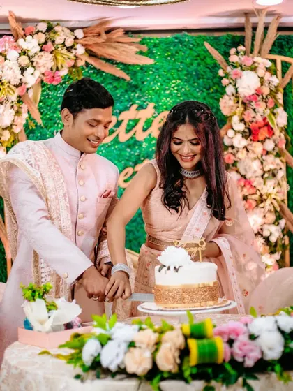 The couple cuts their engagement cake together, a sweet tradition to mark the beginning of their journey.