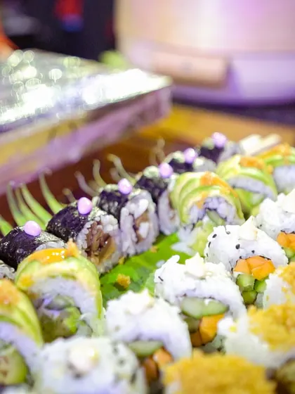A close-up of our assorted sushi platter, showcasing a variety of rolls with different toppings and fillings. We offer a wide range of sushi options to please all palates.