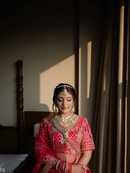 A beautiful portrait of the bride with her eyes closed, as the golden hour sun casts a warm glow on her.