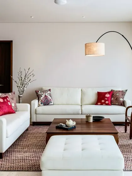 A full view of the living area in the Terrazzo Residence, showcasing the balance between the clean lines of the furniture and the warmth of the wooden coffee table and patterned rug.