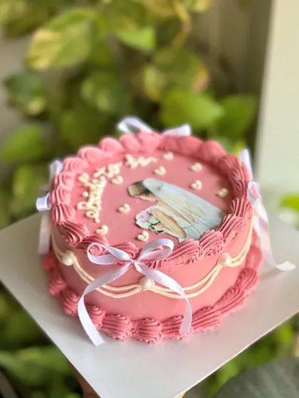 The perfect cake for a bride-to-be. This pink vintage design features an edible illustration of a bride, surrounded by piped hearts and tied with delicate white ribbons.