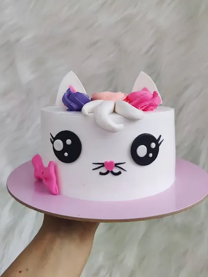 A cutesy kitty unicorn cake, or "caticorn". This whimsical design combines two kid-favorites into one adorable and magical birthday cake.