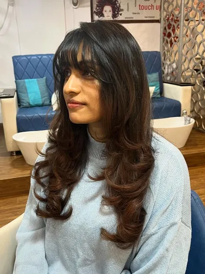 A side view of the soft layers and wispy bangs.