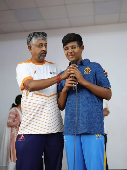 A coach proudly stands with Tanshh Krishna, a moment that captures the strong mentor-student bond we foster.