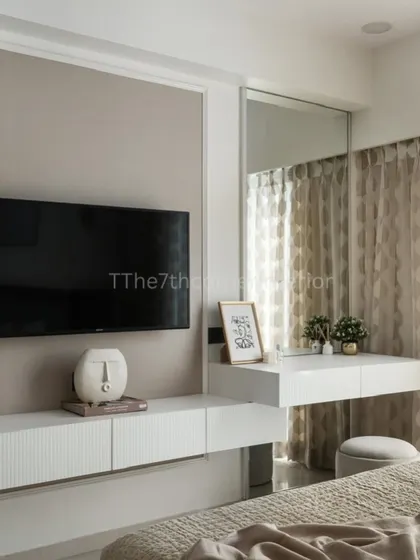 In this master bedroom, I designed a floating TV unit that seamlessly extends into a dressing table with a large mirror. This integrated solution is perfect for optimizing space without sacrificing style.