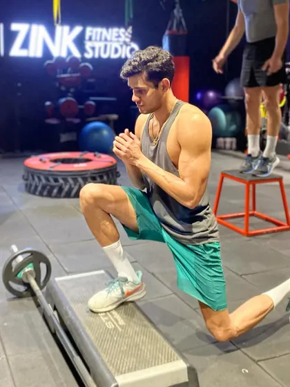 The Bulgarian split squat is a challenging single-leg exercise that builds strength and stability. This client demonstrates perfect form, keeping his chest up and front knee aligned with his foot.