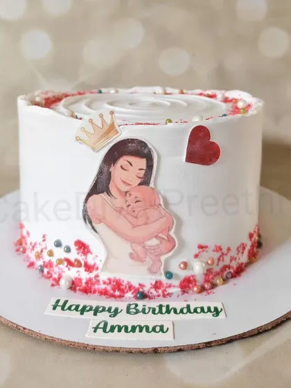 A simple and heartfelt cake for a new mom's birthday. The edible image of a mother and baby is a touching detail on this clean, white cream cake.