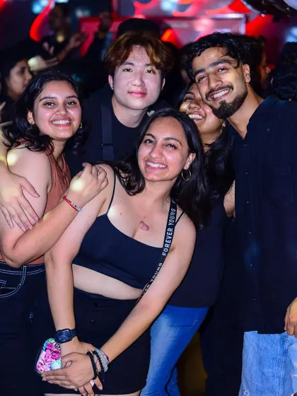 A diverse group of friends, including international guests, having a blast together.