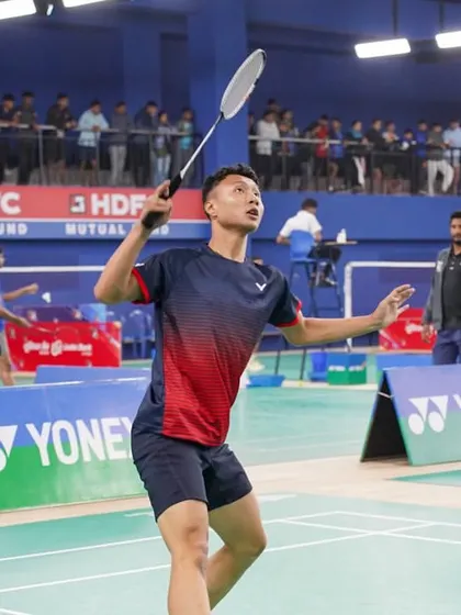 A player serves during the Yonex Sunrise All India Senior National Ranking Tournament. We ensure a professional atmosphere with clear court branding, official umpires, and an engaged audience.