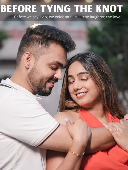 A tender and happy embrace that perfectly illustrates the caption "Before we say 'I do', we celebrate 'us' - the laughter, the love."