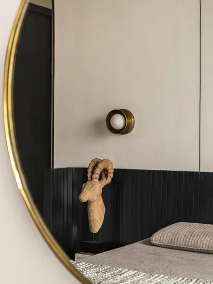 A detail shot in a bedroom of Apartment 3201, showing the reflection in a mirror and the texture of the wall paneling.