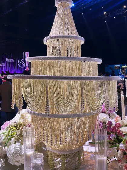 The magnificent centerpiece of our 'Lace Love' table: a multi-tiered chandelier crafted from thousands of delicate pearls. This custom-built structure was the crowning glory of our award-winning design.