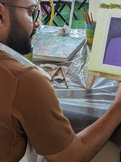A participant painting a beautiful floral-covered door on canvas. The details and colors are simply stunning.
