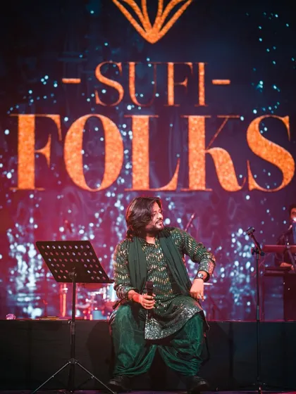 A candid moment on stage, seated before the performance begins. This captures the calm before I pour all my energy into the music.