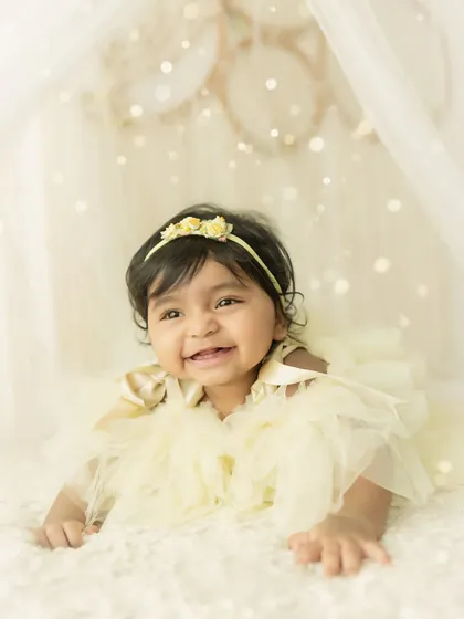 A ray of sunshine. This baby's bright smile lights up the whole frame in this dreamy, yellow-themed milestone shoot.