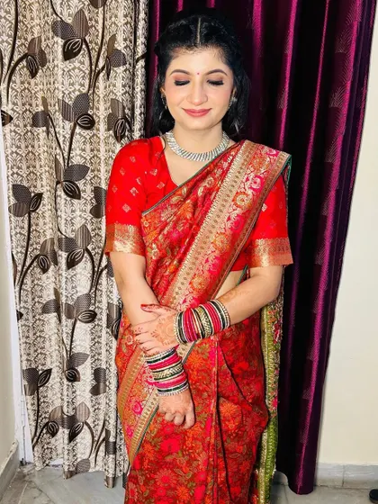The bride looking happy and confident. The makeup is perfect for an intimate family function like a Roka ceremony.