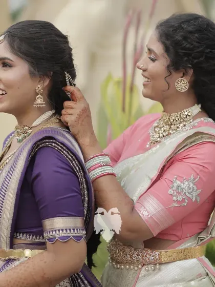 Sisters Vaishnavi and Jahnavi, one in a simple violet silk blouse and the other in a pastel pink creation, celebrating a special bond.