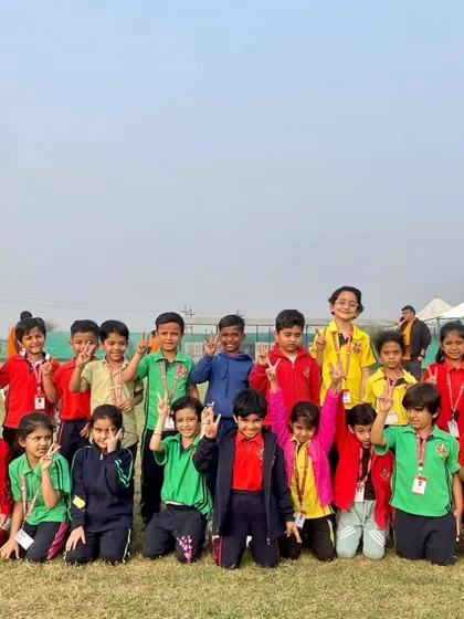 A class poses for a group picture, capturing the shared joy and camaraderie of their day at the adventure camp. These experiences foster friendships and create cherished memories.