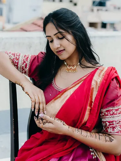 A duplicate image of the client admiring her henna.