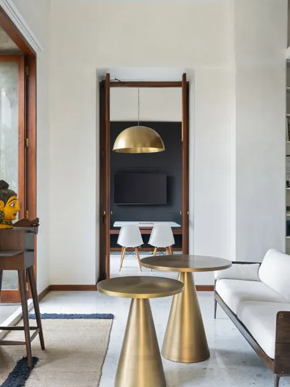 This image of our studio captures our design philosophy of finding beauty in simplicity and the quality of light. The brass pendant lights, some sourced from markets and others custom-made, reflect our love for research and refined details.