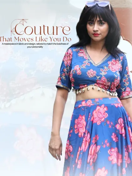 A closer look at our blue and pink floral lehenga set. The V-neck blouse is finished with delicate shell tassels, and the flowing skirt creates a graceful silhouette. It's a perfect blend of modern style and traditional charm.