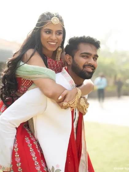 A fun piggyback ride during the Mehendi celebrations. It's these lighthearted, energetic moments that show a couple's true personality.