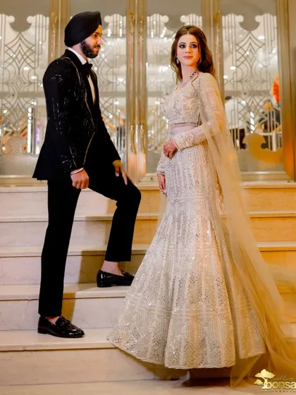A powerful, stylish pose on the staircase, showcasing the couple's confidence and the elegance of the venue.