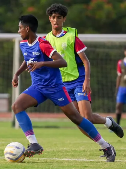A U19 player dribbles at pace, demonstrating the high technical level of our elite squads.
