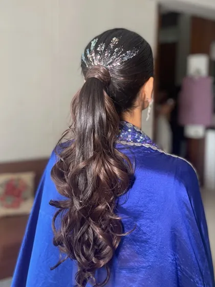 A simple way to elevate a classic ponytail is by adding glitter. For this look, I applied silver glitter at the base of the ponytail for a touch of unexpected sparkle.