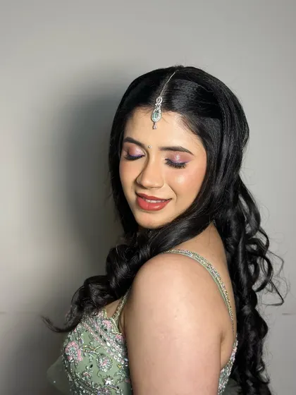 A close-up of the soft, romantic makeup. The shimmering pink eyeshadow and glossy lip create a look that is both youthful and elegant.
