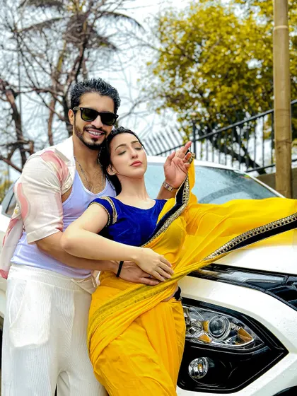 A romantic, Bollywood-style couple shoot with a car, perfect for pre-wedding or promotional content.