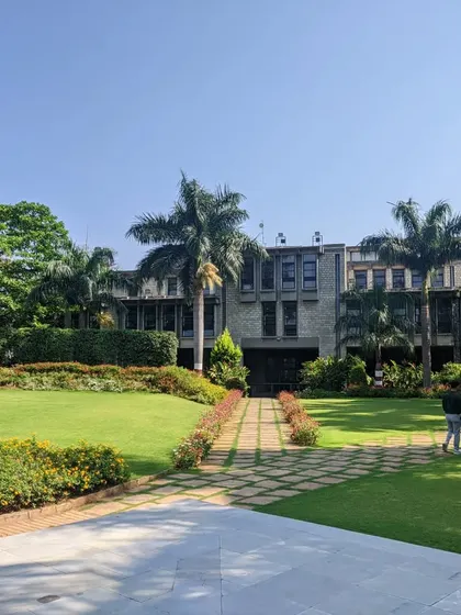 A case study of the IIM Bangalore campus, where manicured lawns and formal pathways contrast with the brutalist architecture, showcasing a masterclass in institutional landscape design.