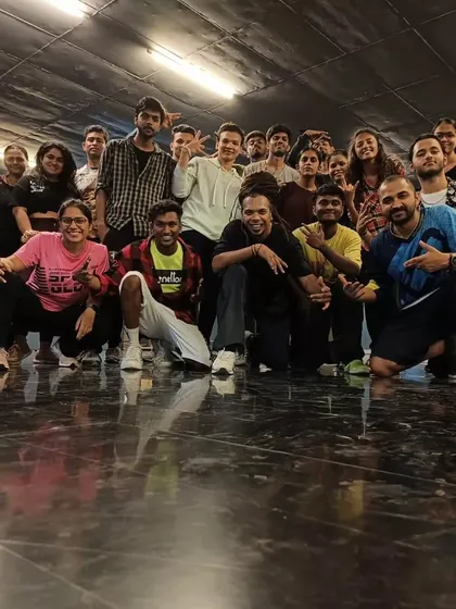 A group photo that says it all: we are a community. Join us to experience the joy of sweating it out on the floor with friends.