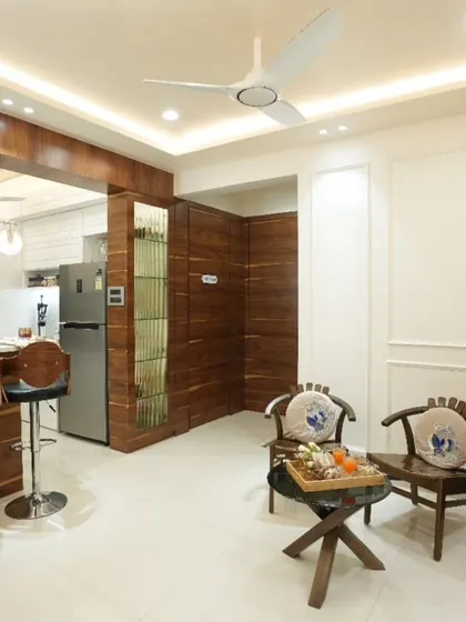 The combination of warm wood paneling and clean white walls creates a beautiful contrast in this living space. The design feels both modern and timeless.
