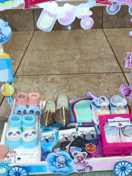 The 'Twins Accessories' carriage, packed with shoes, socks, and bibs for both the boy and the girl.
