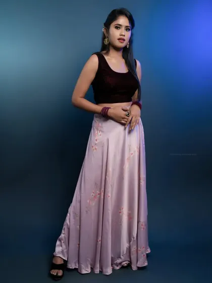 A full-length portrait that showcases the entire ensemble, from the velvet top to the flowing skirt.