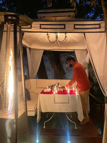 My team and I take great care in setting up each romantic dinner. Here, a staff member adds the final touches to a candlelit table.