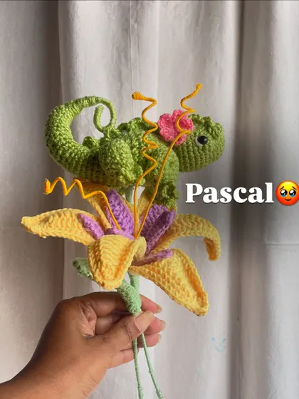 Building the Rapunzel bouquet, adding Pascal the chameleon to a beautiful yellow and purple lily.