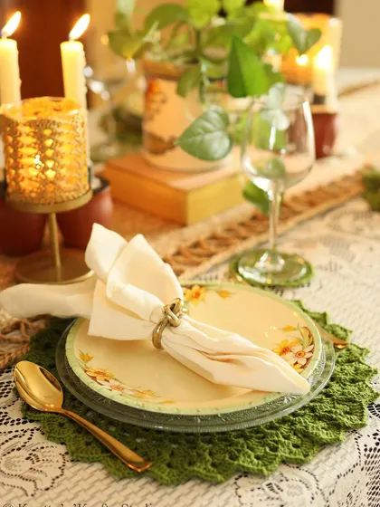 A close-up of the place setting, highlighting the texture of the crochet placemat.