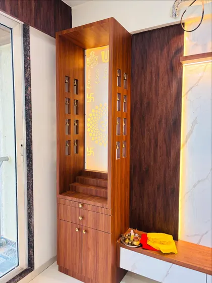Another view of the integrated mandir, showing the detailed cutouts on the side panels and the warm glow from the backlighting.