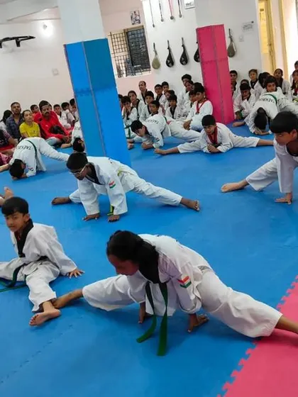 The entire class participates in synchronized stretching.