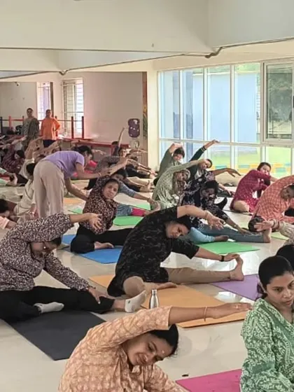 A seated forward bend in a group setting, a great way to stretch the hamstrings and calm the nervous system.
