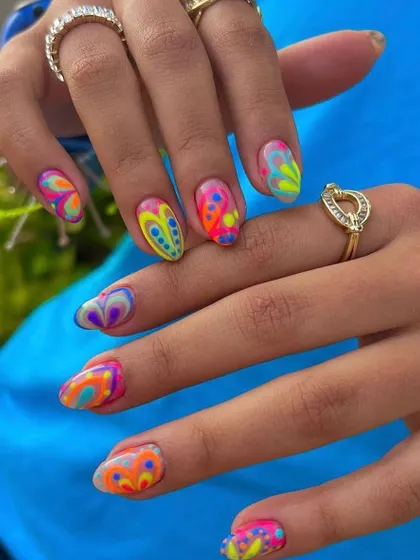 A vibrant and playful psychedelic nail art design. I used a dotting tool and fine brush to layer multiple neon colors, creating a fun, retro-inspired look.