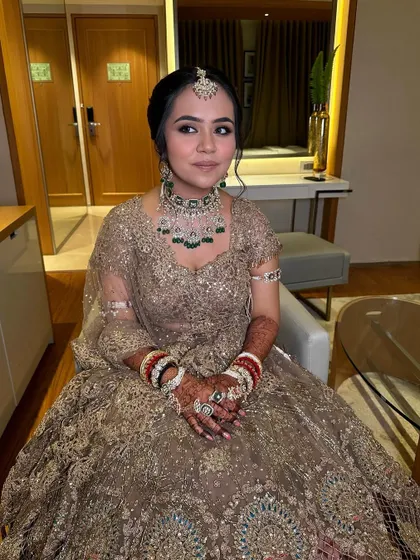 Riya looking absolutely regal in her ivory golden lehenga. The makeup is kept elegant and understated to let her natural beauty and the stunning outfit shine.