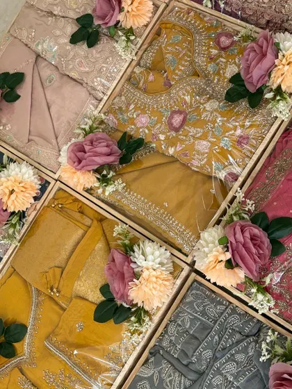 A top-down view of our coordinated wedding gift trays. The consistent use of pastel roses and floral arrangements across different colored outfits creates a harmonious and visually appealing collection.